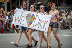 women with sign saying we love dick